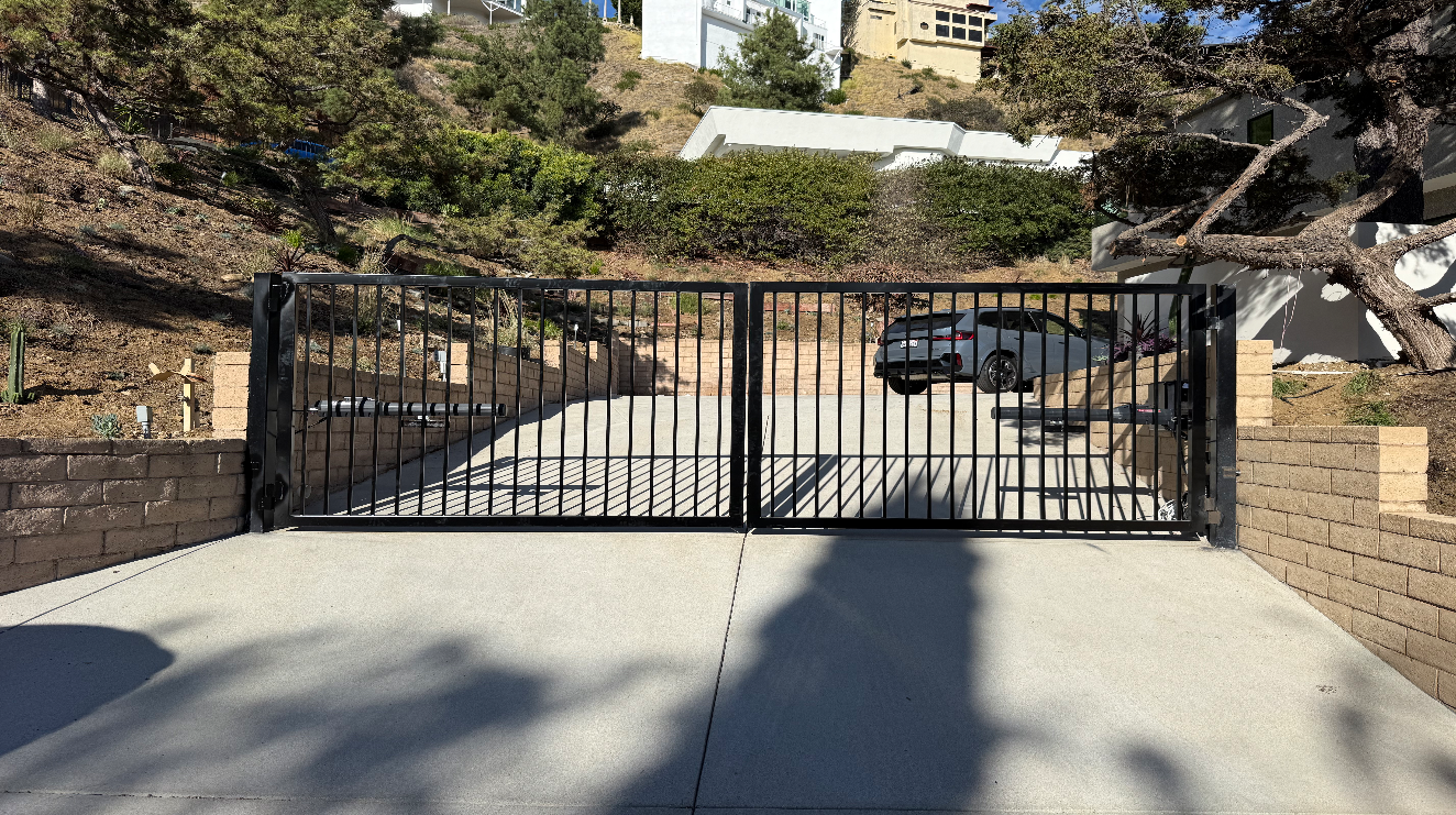 black dual swing gate installed in the driveway